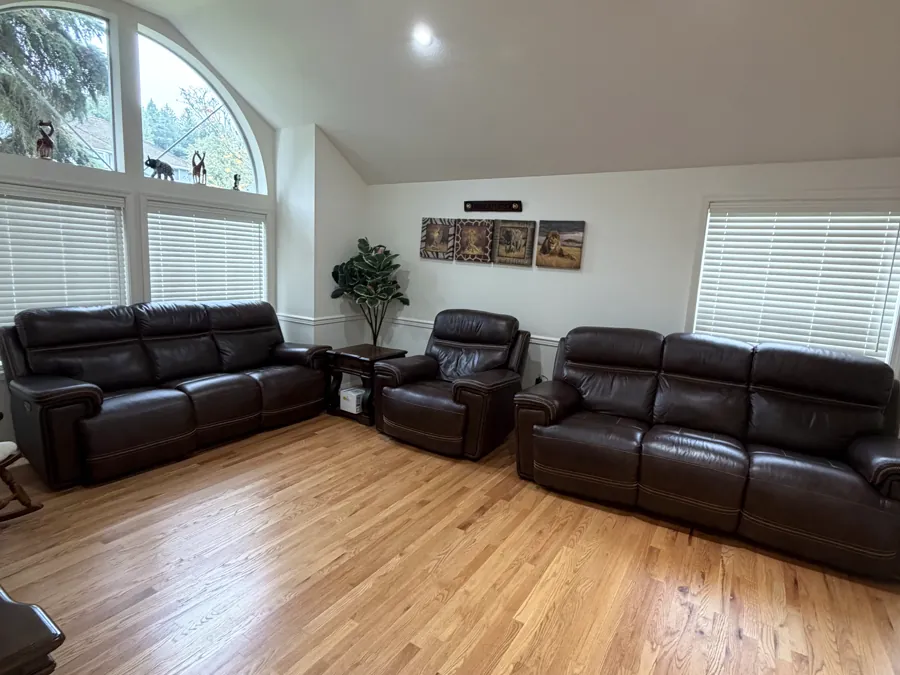 The main living room with two leather sofas facing each other under a vaulted ceiling